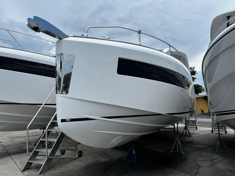 Slide: The Image of 2024 Jeanneau DB37 boat displayed on stands, showcasing sleek design and modern features. - 2