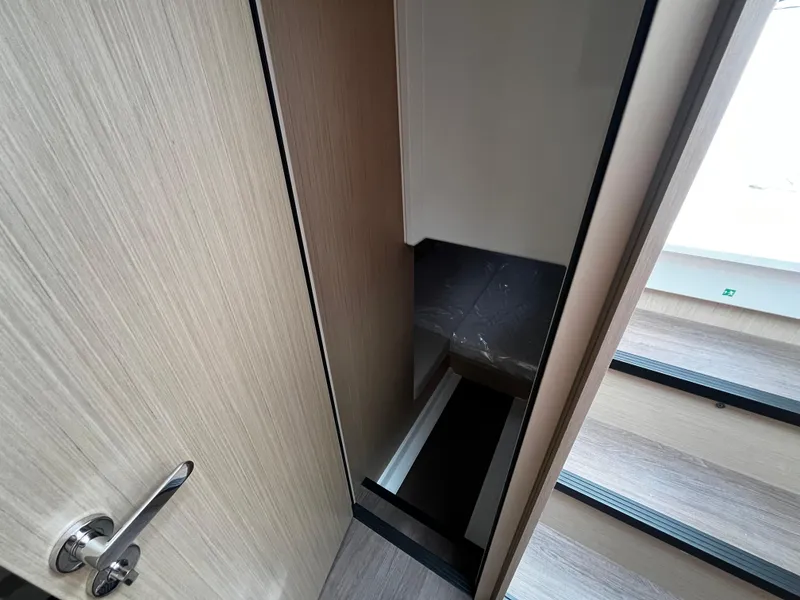 Slide: The Image of 2024 Jeanneau DB37 interior stairway with wooden finish and modern design. - 27