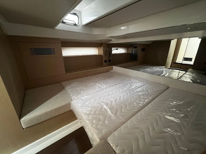 Slide: The Image of 2024 Jeanneau DB37 cabin interior with modern design and comfortable bedding. - 28