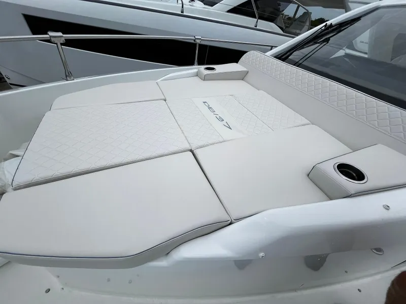 Slide: The Image of 2024 Jeanneau DB37 boat with luxurious white sunbed and cup holders. - 30