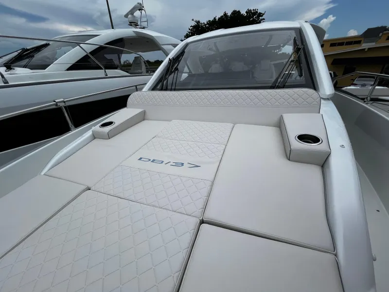 Slide: The Image of 2024 Jeanneau DB37 yacht with sleek white deck and luxurious seating. - 31