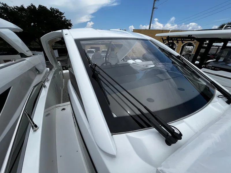 Slide: The Image of 2024 Jeanneau DB37 boat with sleek design and modern windshield wipers. - 32