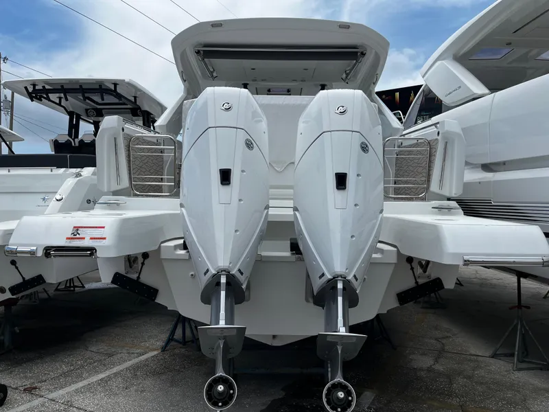 Slide: The Image of 2024 Jeanneau DB37 boat with dual outboard engines, rear view. - 4