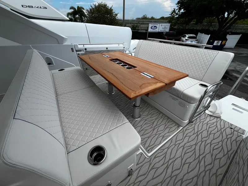 Slide: The Image of 2024 Jeanneau DB37 yacht interior with elegant seating and wooden table. - 6