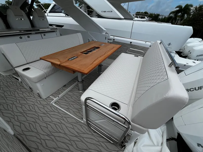 Slide: The Image of 2024 Jeanneau DB37 yacht interior with elegant seating and wooden table. - 7