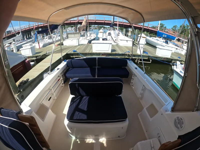 Slide: The Image of 2005 Hunt Yachts Surfhunter 25 with spacious seating at a marina dock. - 12