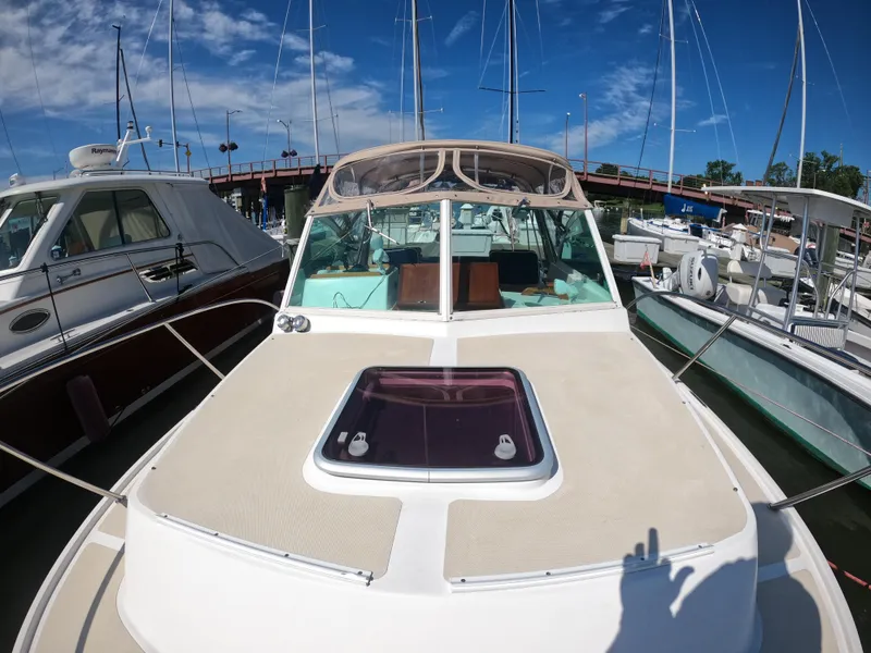 Slide: The Image of 2005 Hunt Yachts Surfhunter 25 docked, showcasing sleek design and spacious deck. - 20