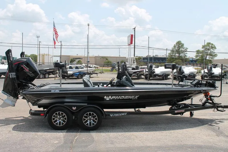 Slide: The Image of 2025 Phoenix 920 Elite boat, black, parked on trailer in outdoor lot. - 3