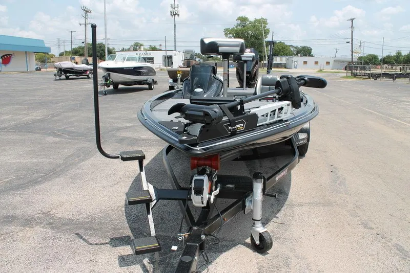Slide: The Image of 2025 Phoenix 920 Elite boat on trailer in parking lot, showcasing front view and equipment. - 7
