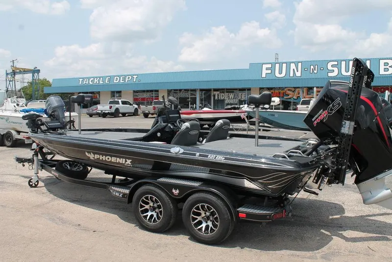 Slide: The Image of 2025 Phoenix 920 Elite boat on trailer outside tackle shop, sunny day. - 9