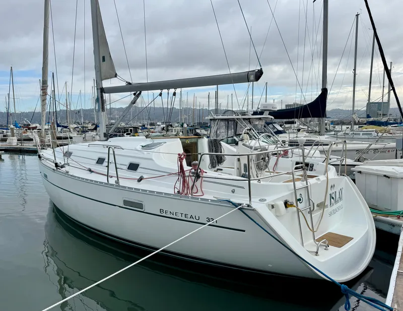 Slide: The Image of 2001 Beneteau Oceanis 331 sailboat docked in marina, overcast sky. - 1