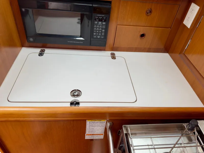 Slide: The Image of 2001 Beneteau Oceanis 331 yacht kitchen with microwave and storage compartments. - 12