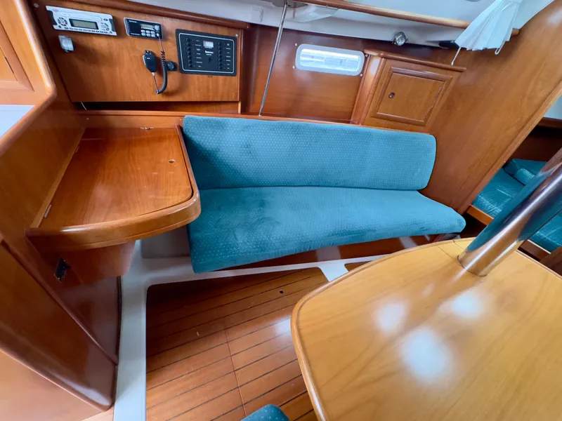 Slide: The Image of Interior of 2001 Beneteau Oceanis 331 sailboat with wooden furnishings and blue seating. - 15