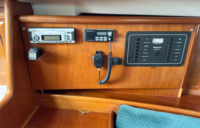 Slide: The Image of Control panel of a 2001 Beneteau Oceanis 331 sailboat with radio and switches. - 16
