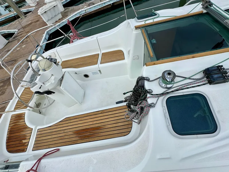 Slide: The Image of 2001 Beneteau Oceanis 331 sailboat deck with wooden accents and steering wheel. - 4