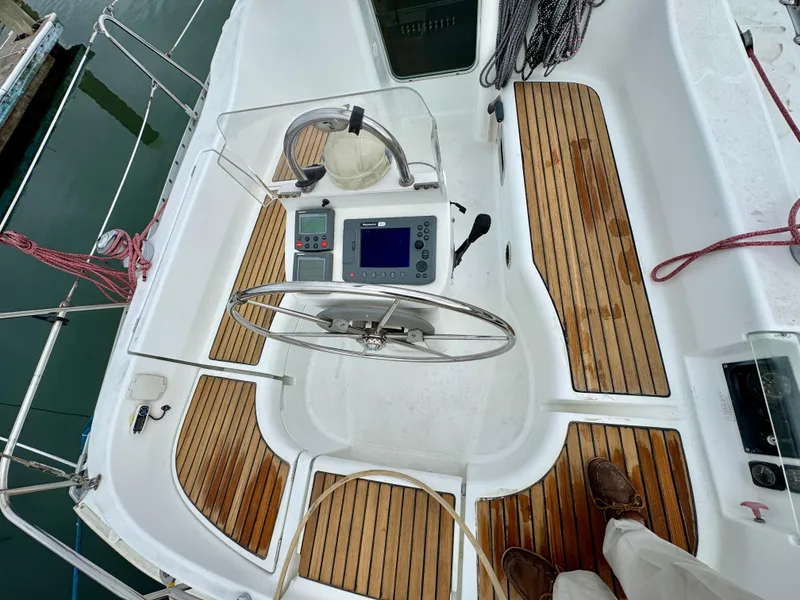 Slide: The Image of Cockpit of 2001 Beneteau Oceanis 331 sailboat with wooden flooring and navigation equipment. - 5