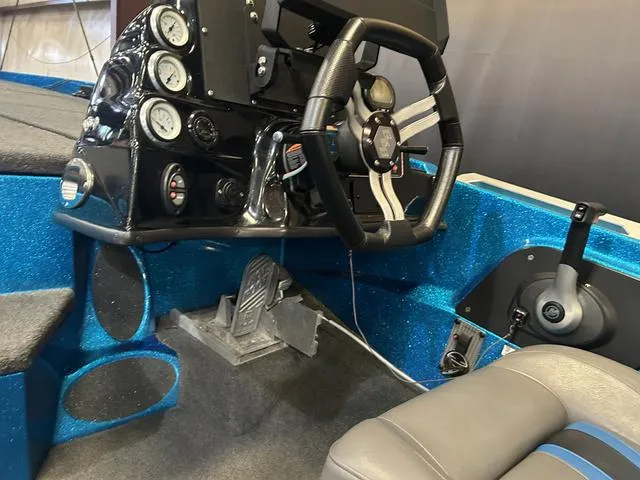 Slide: The Image of 2018 Bass Cat Lynx boat interior with steering wheel and control panel. - 12