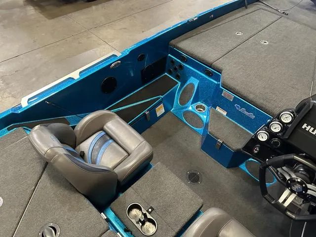 Slide: The Image of 2018 Bass Cat Boats Lynx interior with gray seats and blue accents. - 13