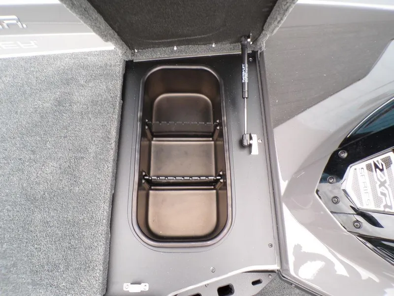 Slide: The Image of 2025 Skeeter ZXR21 boat storage compartment with open lid, showcasing interior space. - 15
