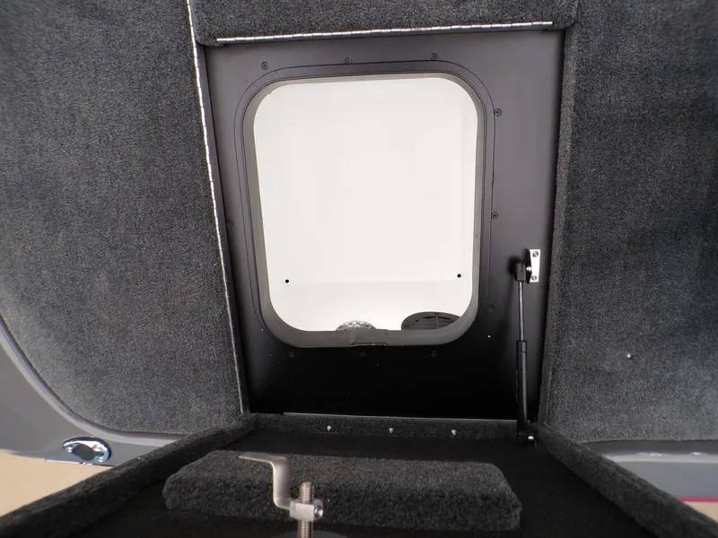 Slide: The Image of 2025 Skeeter ZXR21 boat storage compartment with carpeted interior and hatch. - 20