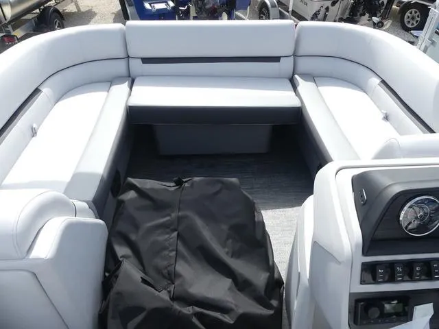 Slide: The Image of 2025 Sweetwater SW2286QS pontoon boat interior with plush seating and control panel. - 10