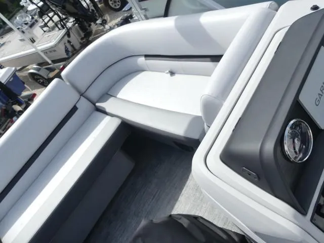 Slide: The Image of 2025 Sweetwater SW2286QS boat interior with white seating and modern dashboard. - 12