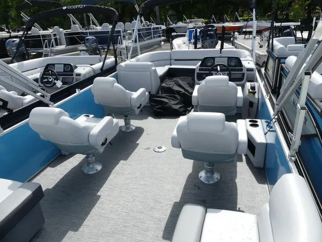 Slide: The Image of 2025 Sweetwater SW2286QS pontoon boat with spacious seating and modern dashboard. - 3