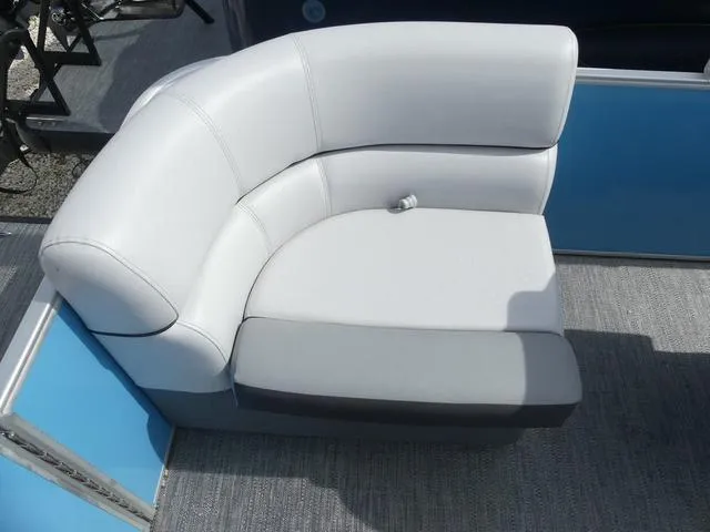 Slide: The Image of White and gray seating on 2025 Sweetwater SW2286QS boat, featuring blue paneling. - 5
