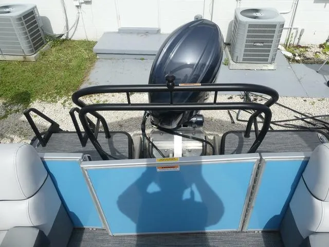 Slide: The Image of 2025 Sweetwater SW2286QS boat with outboard motor, blue paneling, and seating. - 6