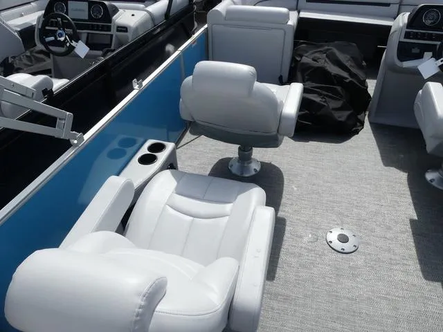 Slide: The Image of Interior of 2025 Sweetwater SW2286QS boat with white seating and modern dashboard. - 7