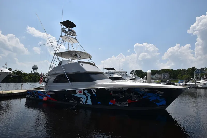 The Image of 1997 Viking 50 Convertible yacht with custom hull art docked at marina. - 0