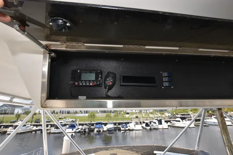 Slide: The Image of 1997 Viking 50 Convertible yacht electronics panel with marina view. - 10