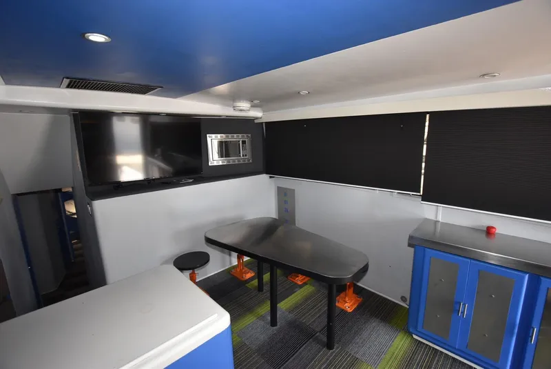 Slide: The Image of Interior of a 1997 Viking 50 Convertible yacht with modern seating and cabinetry. - 11