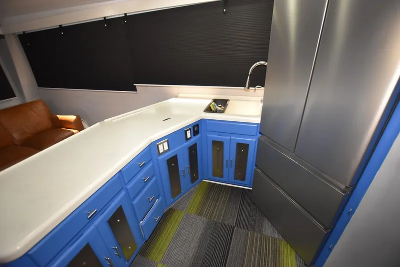 Slide: The Image of Modern kitchen in 1997 Viking 50 Convertible yacht with blue cabinets and stainless steel appliances. - 14