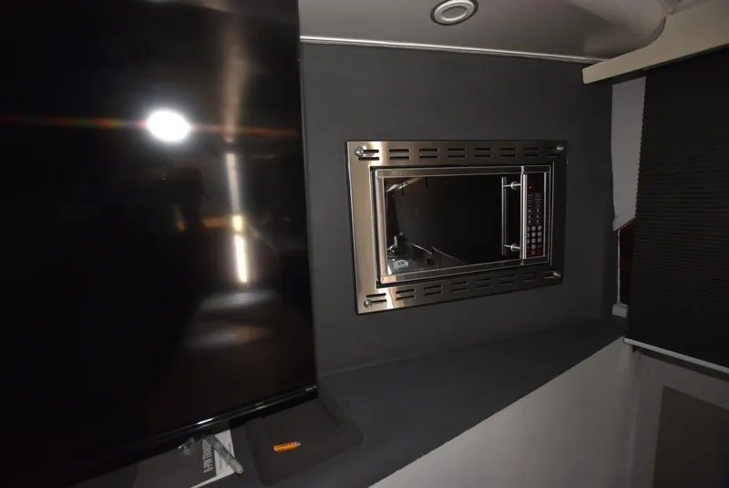 Slide: The Image of Interior of 1997 Viking 50 Convertible yacht with built-in microwave and TV. - 16