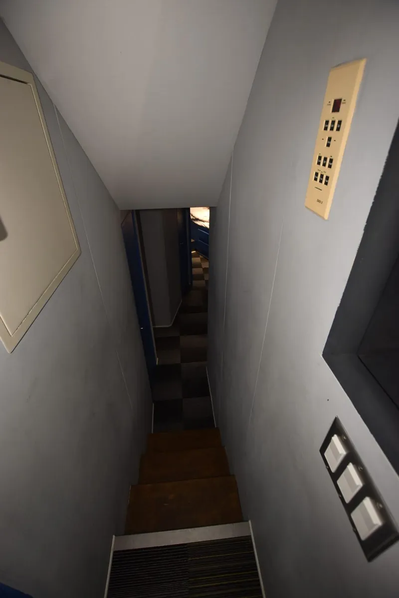 Slide: The Image of Narrow hallway inside 1997 Viking 50 Convertible yacht with control panel on wall. - 17