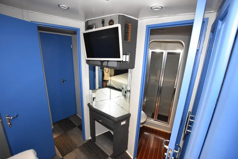 Slide: The Image of 1997 Viking 50 Convertible yacht interior with TV, mirror, and shower. - 20