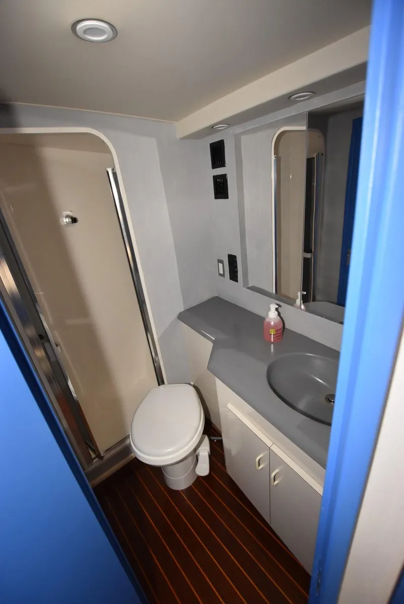 Slide: The Image of Bathroom interior of 1997 Viking 50 Convertible yacht with shower, sink, and toilet. - 23