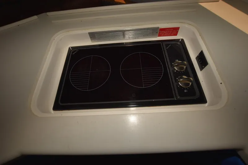 Slide: The Image of 1997 Viking 50 Convertible boat stove with dual burners in a compact kitchen setup. - 24