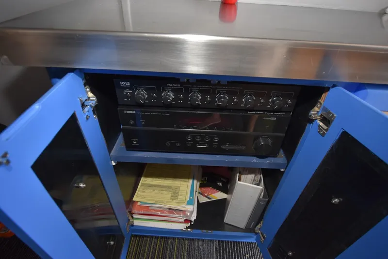 Slide: The Image of Open blue cabinet with audio equipment and documents inside, Viking 50 Convertible, 1997. - 26