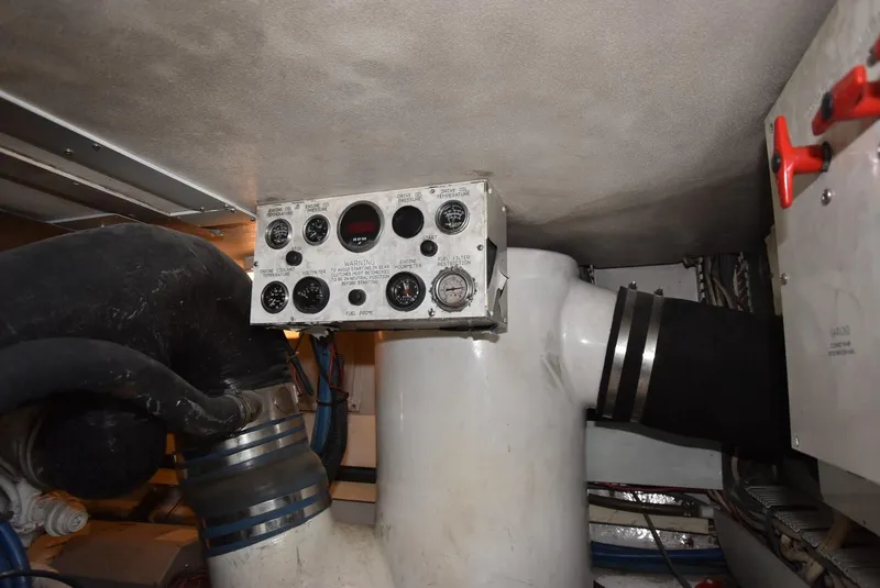 Slide: The Image of Engine room of 1997 Viking 50 Convertible yacht with control panel and piping. - 28