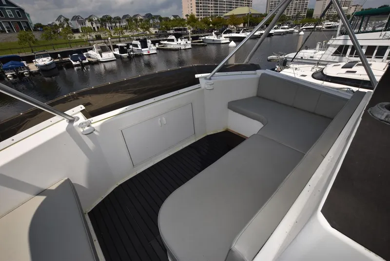Slide: The Image of Spacious seating area on a 1997 Viking 50 Convertible yacht, docked at a marina. - 3