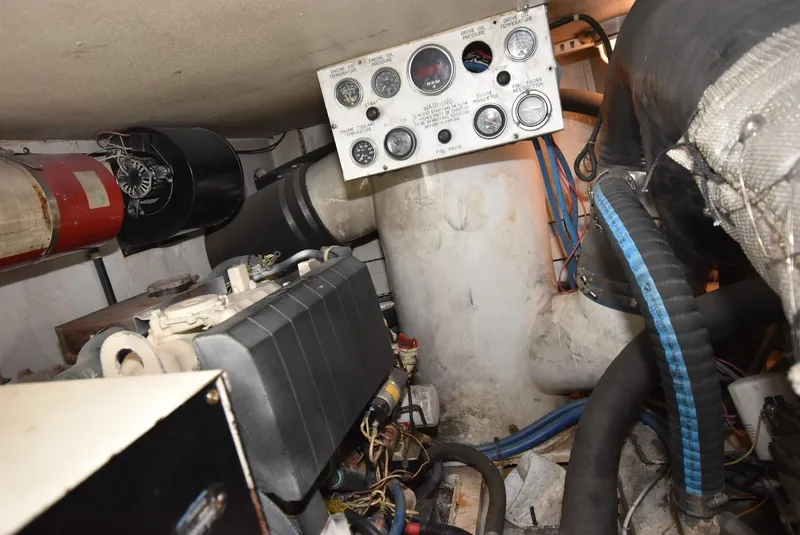 Slide: The Image of Engine room of a 1997 Viking 50 Convertible boat, featuring gauges and mechanical components. - 33