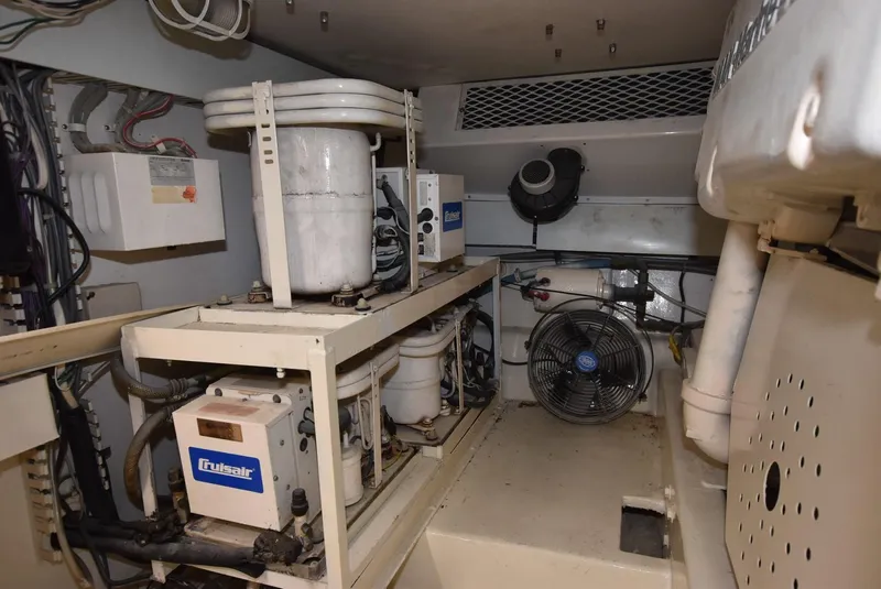 Slide: The Image of Engine room of 1997 Viking 50 Convertible yacht with mechanical equipment and ventilation system. - 36