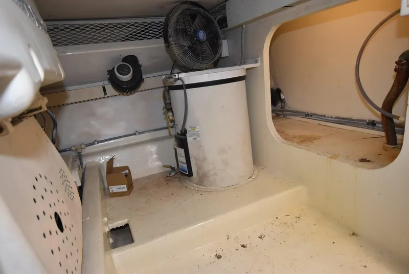 Slide: The Image of Engine room of 1997 Viking 50 Convertible boat, featuring ventilation and storage components. - 37