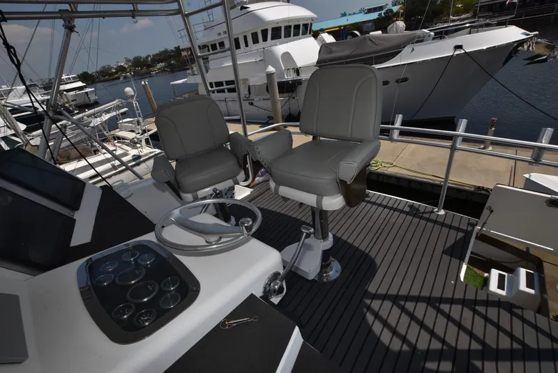 Slide: The Image of 1997 Viking 50 Convertible yacht helm with two captain chairs and control panel. - 4