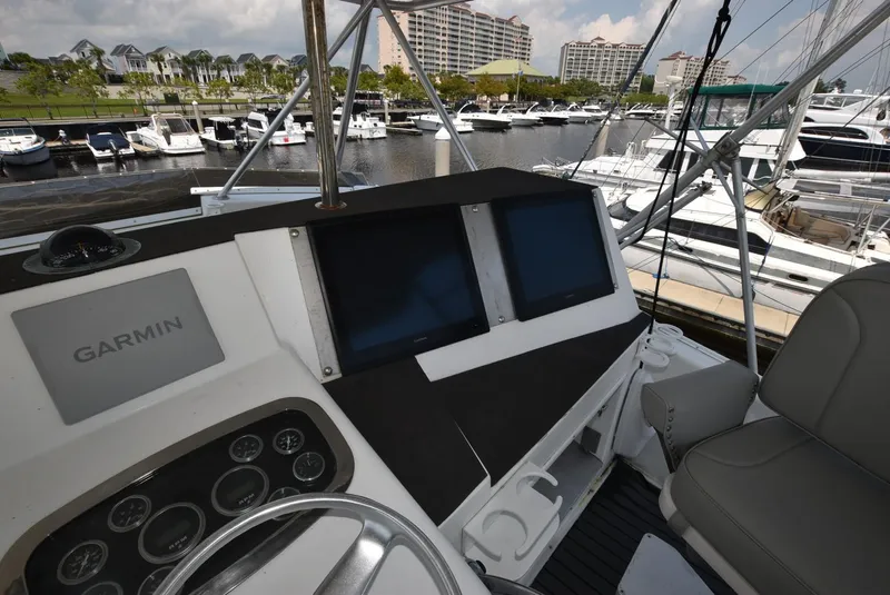 Slide: The Image of Cockpit of 1997 Viking 50 Convertible yacht with Garmin navigation system at marina. - 5