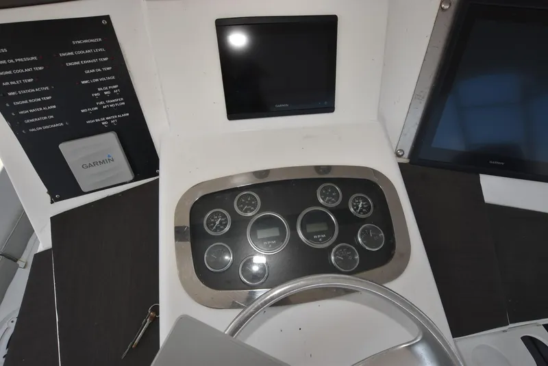 Slide: The Image of 1997 Viking 50 Convertible dashboard with gauges and Garmin navigation system. - 7