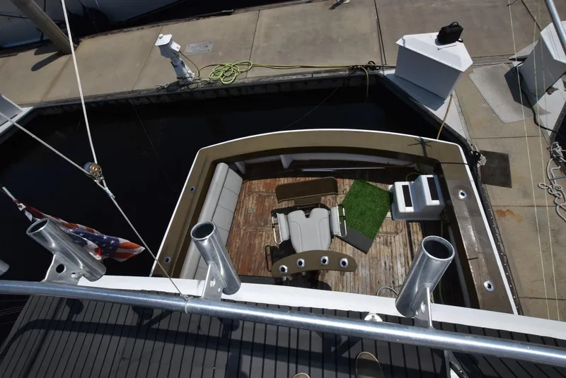 Slide: The Image of 1997 Viking 50 Convertible yacht deck with fishing chair and rod holders. - 9