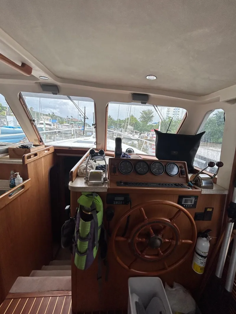 Slide: The Image of 1999 Mainship 350 Trawler helm with wooden wheel and navigation instruments. - 10